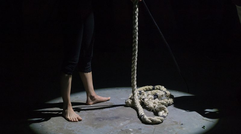 man holding brown rope