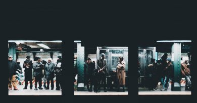 people standing and waiting on train station