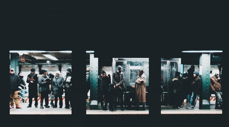 people standing and waiting on train station