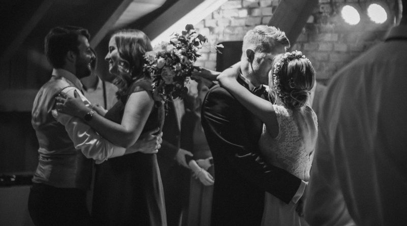 grayscale photo of man and woman kissing