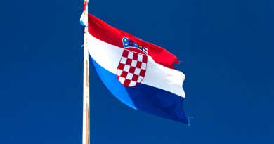 white, red, and blue flag in the pole