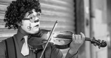 grayscale photo of man playing violin